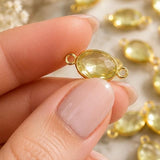 Macro photograph of a faceted Lemon Topaz connector