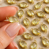 Gold-framed Lemon Topaz connectors showing natural differences in shape and color