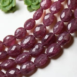 Close-up of  Pink Sapphire beads showing faceted surfaces, natural inclusions and varied pink color