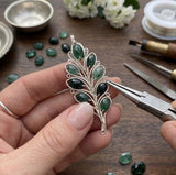 Natural freeform emerald rose cut cabochon shown in handcrafted jewelry design in process