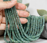 Natural green blue tourmaline beads 3mm to 4.5mm faceted rondelle gemstones displayed in hand for jewelry making