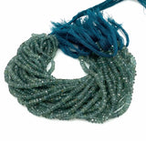 Blue green tourmaline beads displayed in multiple faceted rondelle strands for necklaces bracelets and jewelry designs