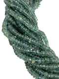 Close up of Blue green tourmaline faceted rondelle beads showing natural teal green color variations and sparkle