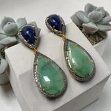 Natural emerald and blue sapphire earrings with genuine pave diamonds displayed as luxury statement jewelry