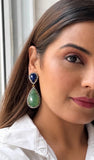 Close up of model wearing emerald blue sapphire pave diamond earrings showing 2.10 inch drop length