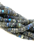 Natural Labradorite faceted heishi beads with blue flash on a white background