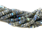 Macro view of natural Labradorite faceted heishi gemstone beads
