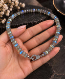 Natural Labradorite beaded choker held in hand showing gemstone size, blue flash and genuine pave diamond clasp