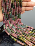 AAA natural Watermelon Tourmaline faceted Heishi beads held in hand showing multicolor pink green and golden gemstone tones