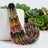 Faceted multi tourmaline bead strands displayed with natural pink, green and earthy color variations