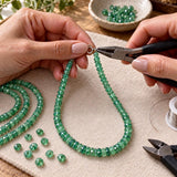 Zambian emerald beads being used for jewelry making with beading tools and natural green gemstones