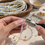 Natural Ethiopian opal beads being used for jewelry making with beading tools and gemstone supplies