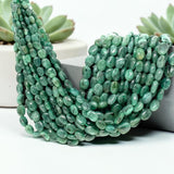 Natural Emerald smooth oval gemstone bead strands showing polished green color variations for jewelry making