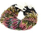 Natural Watermelon Tourmaline round bead strands bundled on white background for wholesale jewelry making supplies