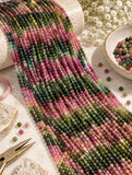 Natural Tourmaline round bead strands displayed for jewelry making showing pink green and multicolor gemstone patterns