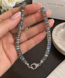 AAA natural Labradorite beaded necklace held in hand showing multi fire gemstone beads and genuine pave diamond clasp